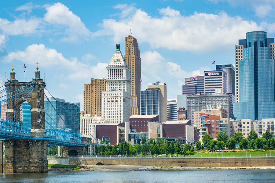 Contact - The Cincinnati Skyline and Ohio River, Seen From Covington, Kentucky Displaying a Bridge and Many Tall Buildings